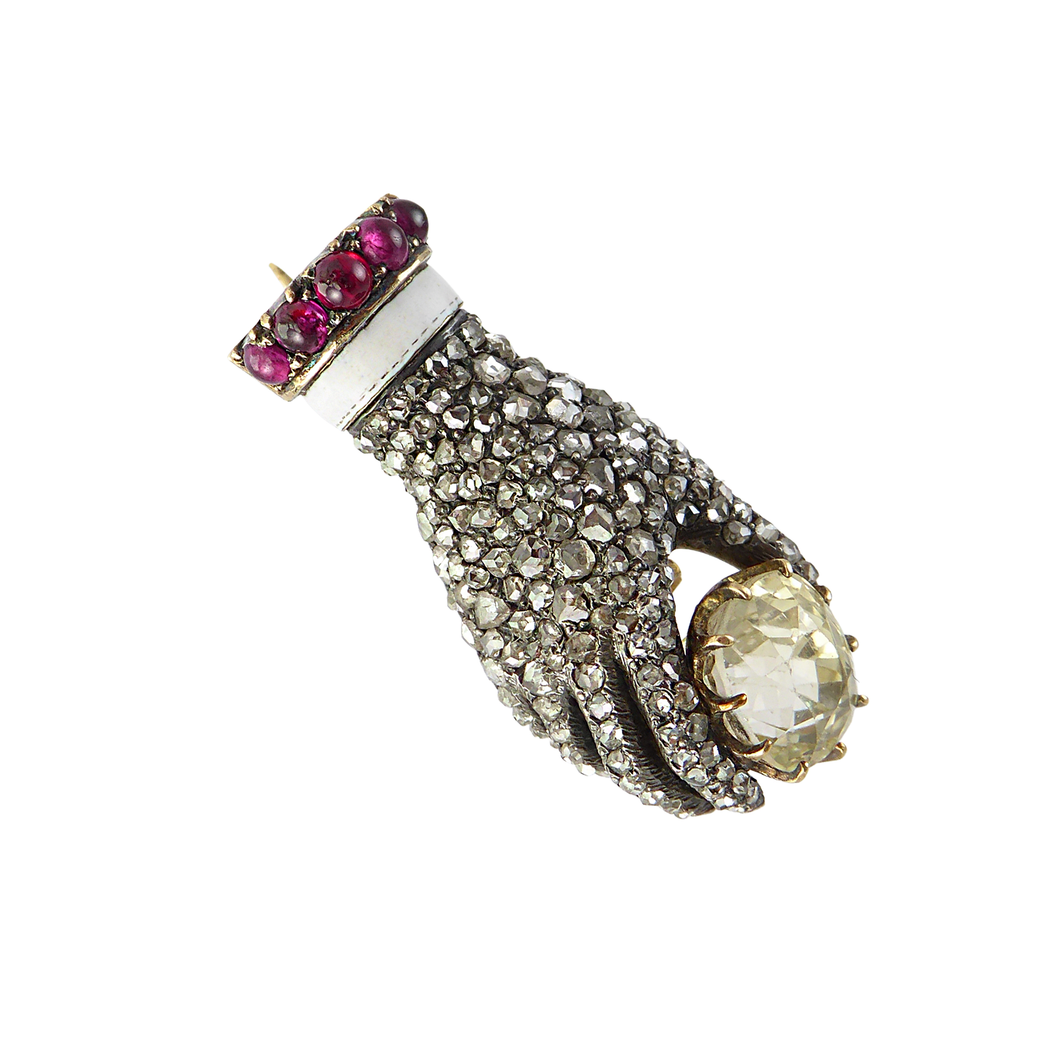 19th century rose cut diamond, ruby and yellow sapphire hand brooch, c.1890, modelled holding the single cushion cut yellow sapphire between thumb and forefinger,